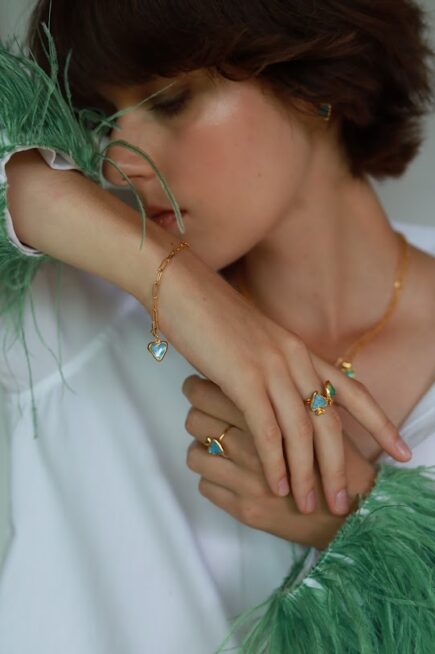10 decoart jewellery on model. hand made earrings, rings, pendants. Colourful, vibrant pieces.